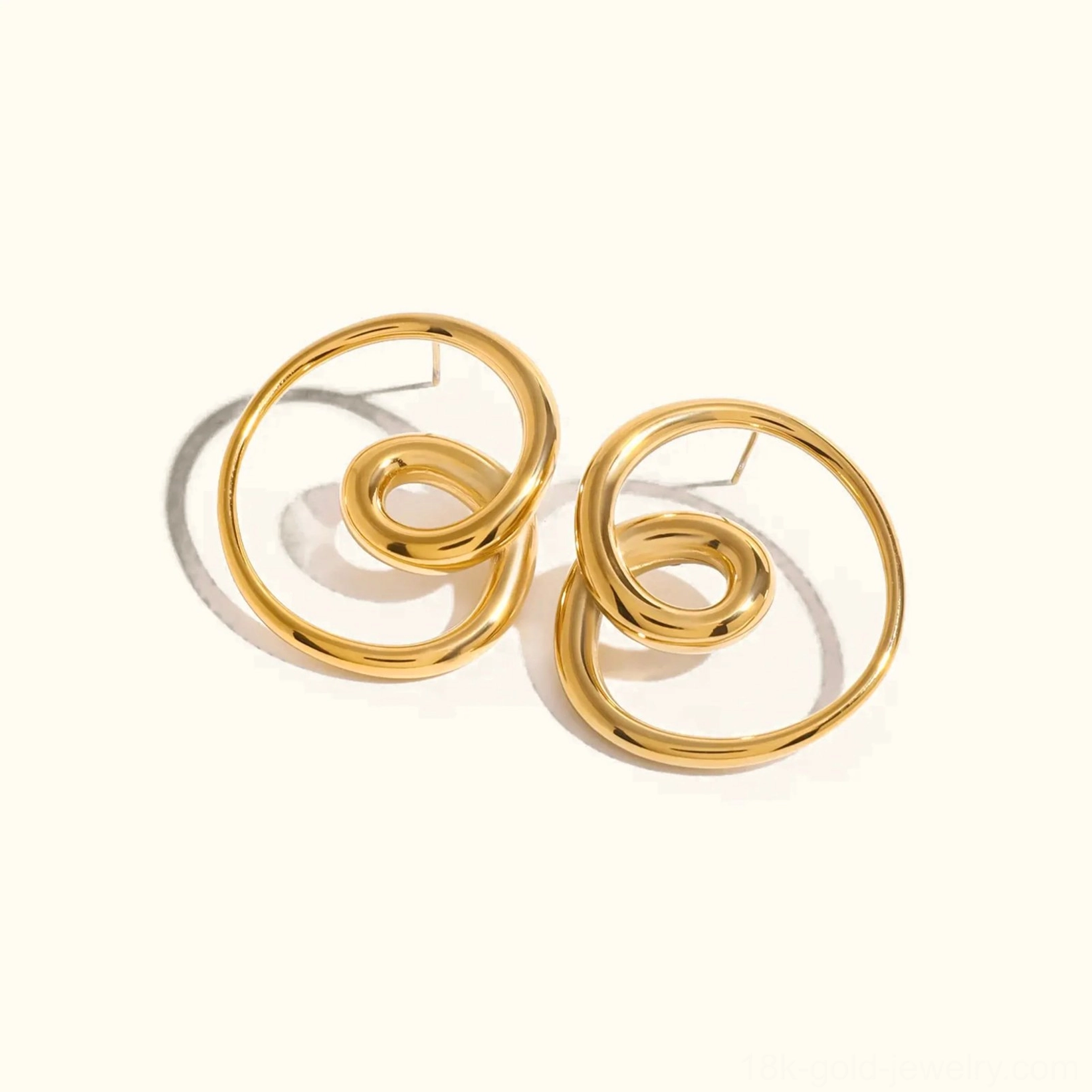 18K gold twisted spiral stud earrings front view flat lay polished finish studio shot