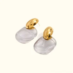 18K gold two-tone chunky drop earrings flat lay top-down view on white background showcasing polished silver irregular disc pendant with gold-toned ear stud detail