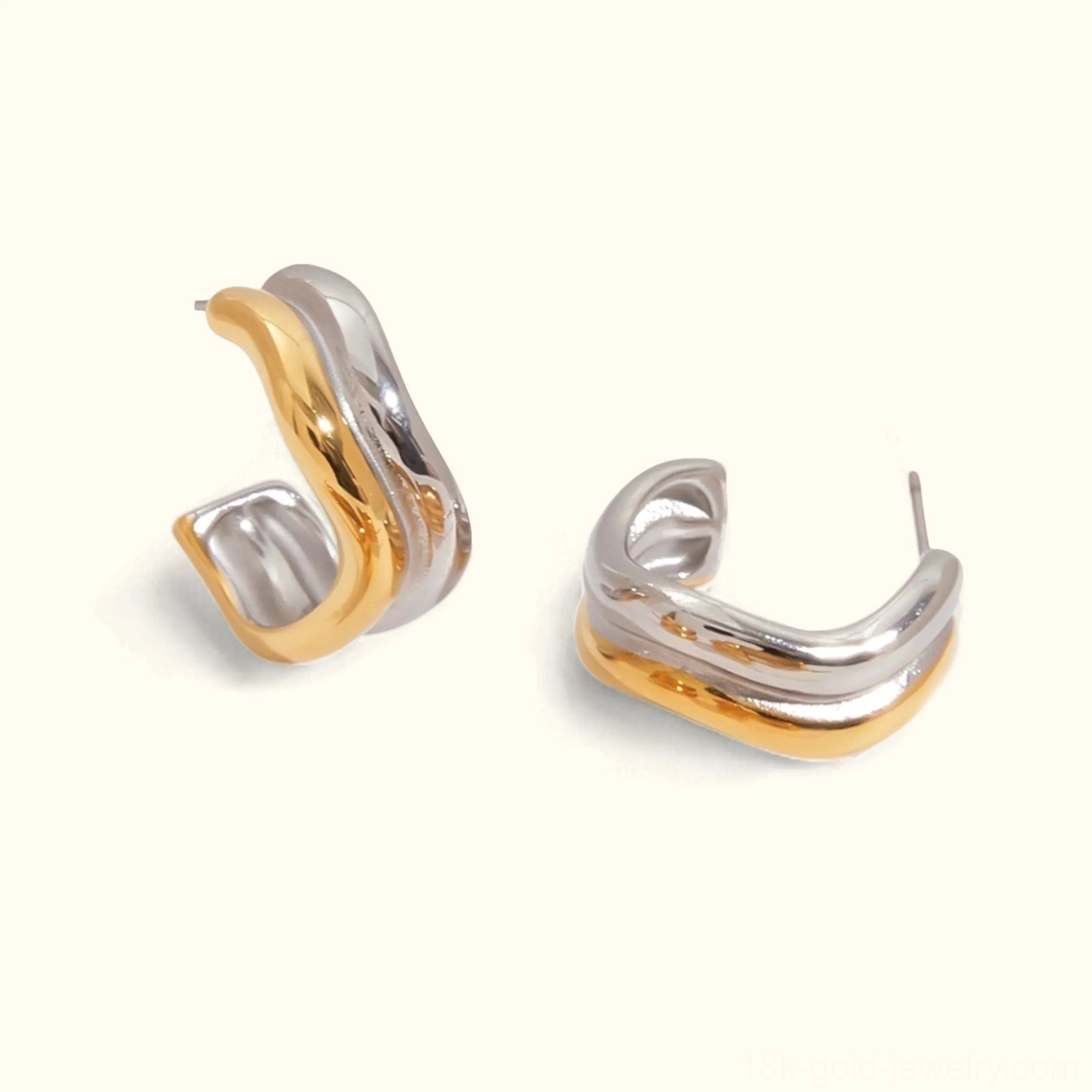18K gold two-tone dual-curve hoop earrings flat lay, front view, mixed metal design, polished finish