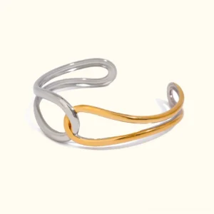 18K gold two-tone open cuff bangle featuring intertwined silver and gold curved metal bands, flat lay product photography with minimalist white background