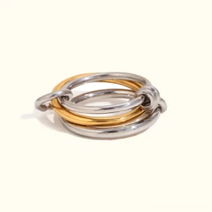 18K yellow gold and silver two-tone stackable ring set flat lay front view polished metal bands interlocking design luxury minimalist jewelry