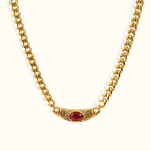 18K gold vintage gem necklace with ruby red oval pendant and micro-paved zircon accents, flat lay product view