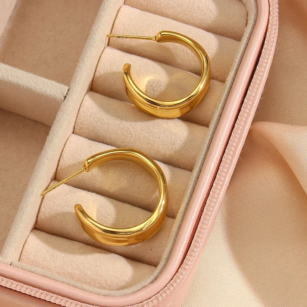 18K gold wave hoop earrings top-down view pink velvet jewelry storage box display