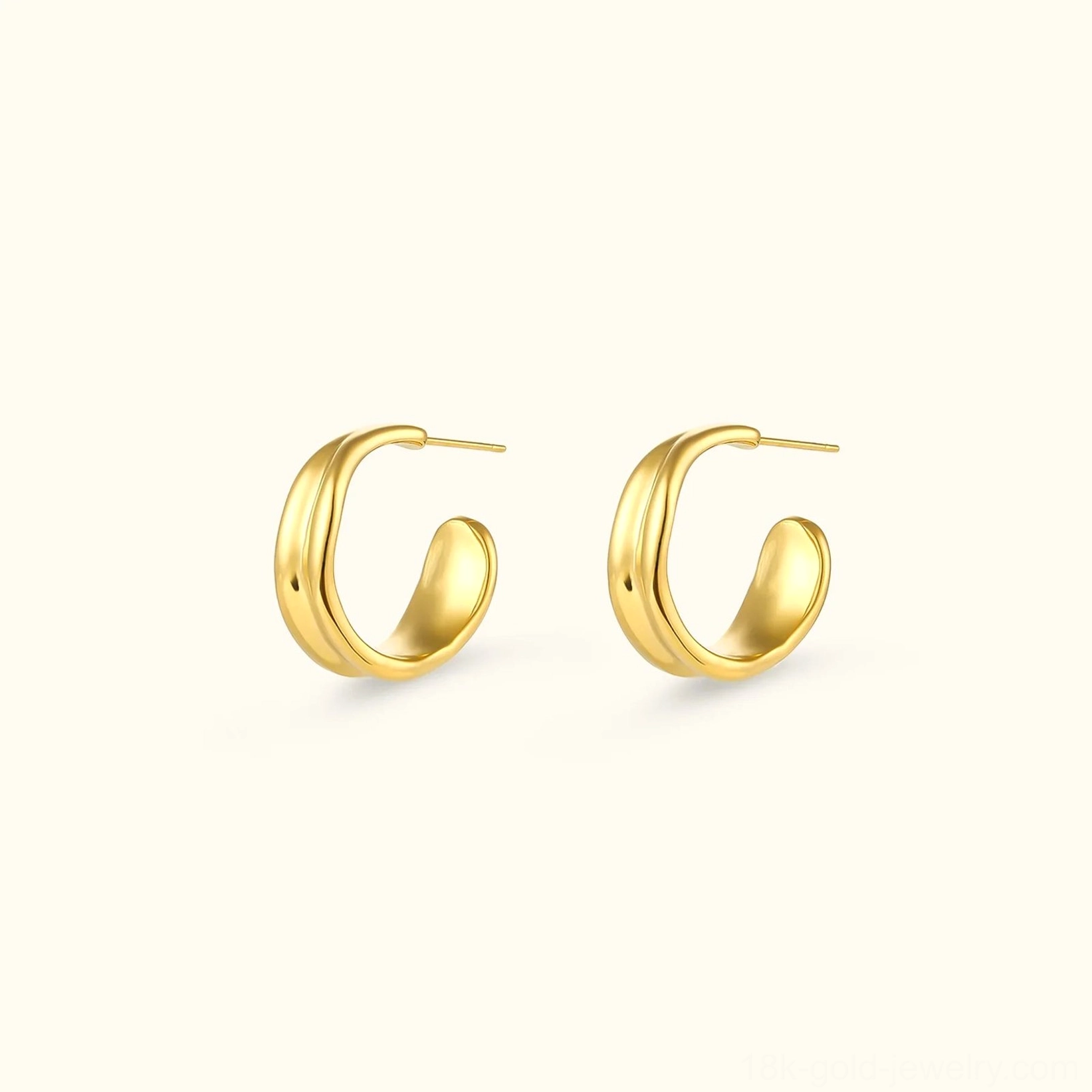 18K gold wave hoop earrings flat lay front view polished C-shaped design on beige background