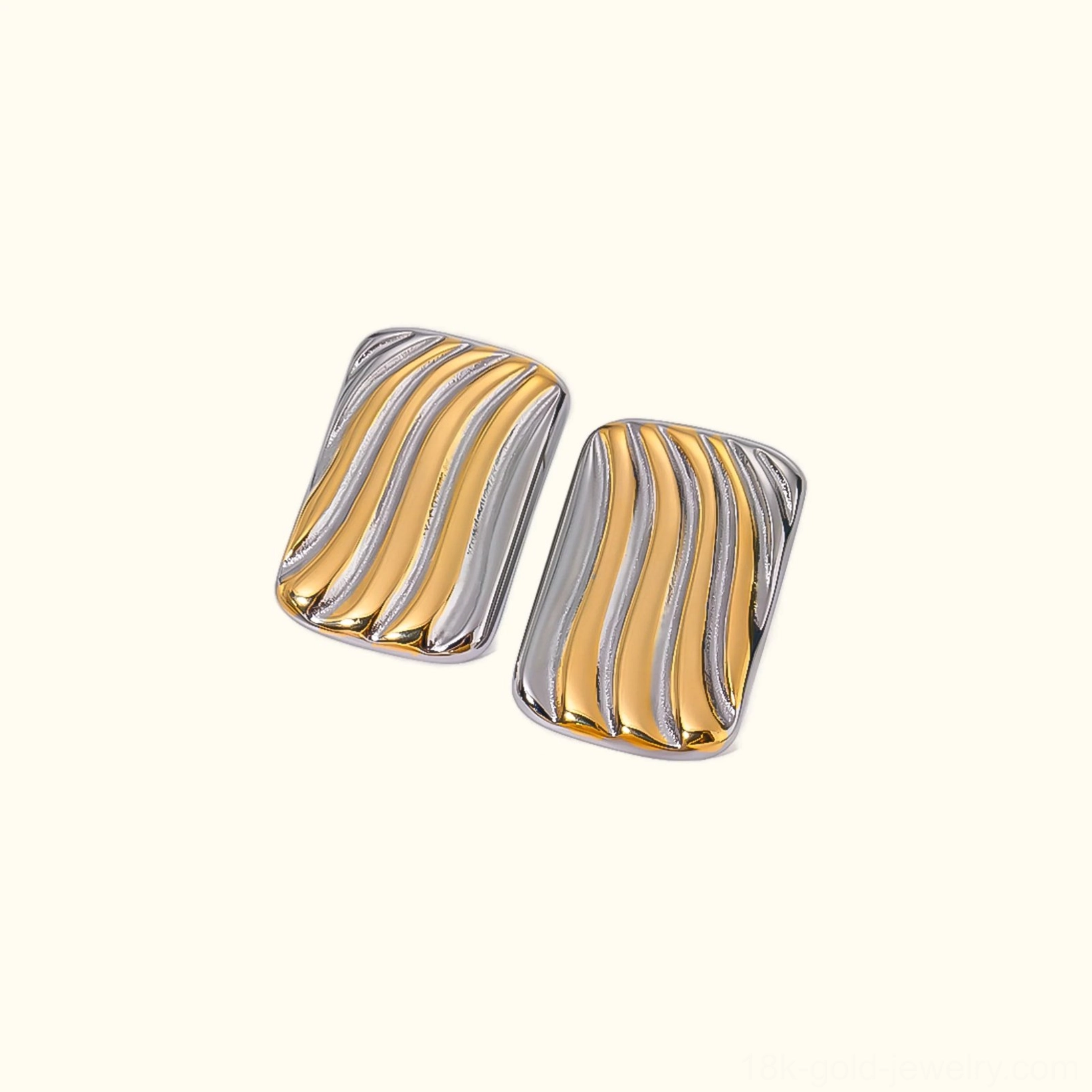 18K gold wavy rectangular stud earrings oblique angle stone texture background