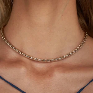 18K gold wheat chain choker necklace worn on female model neck close-up detail shot