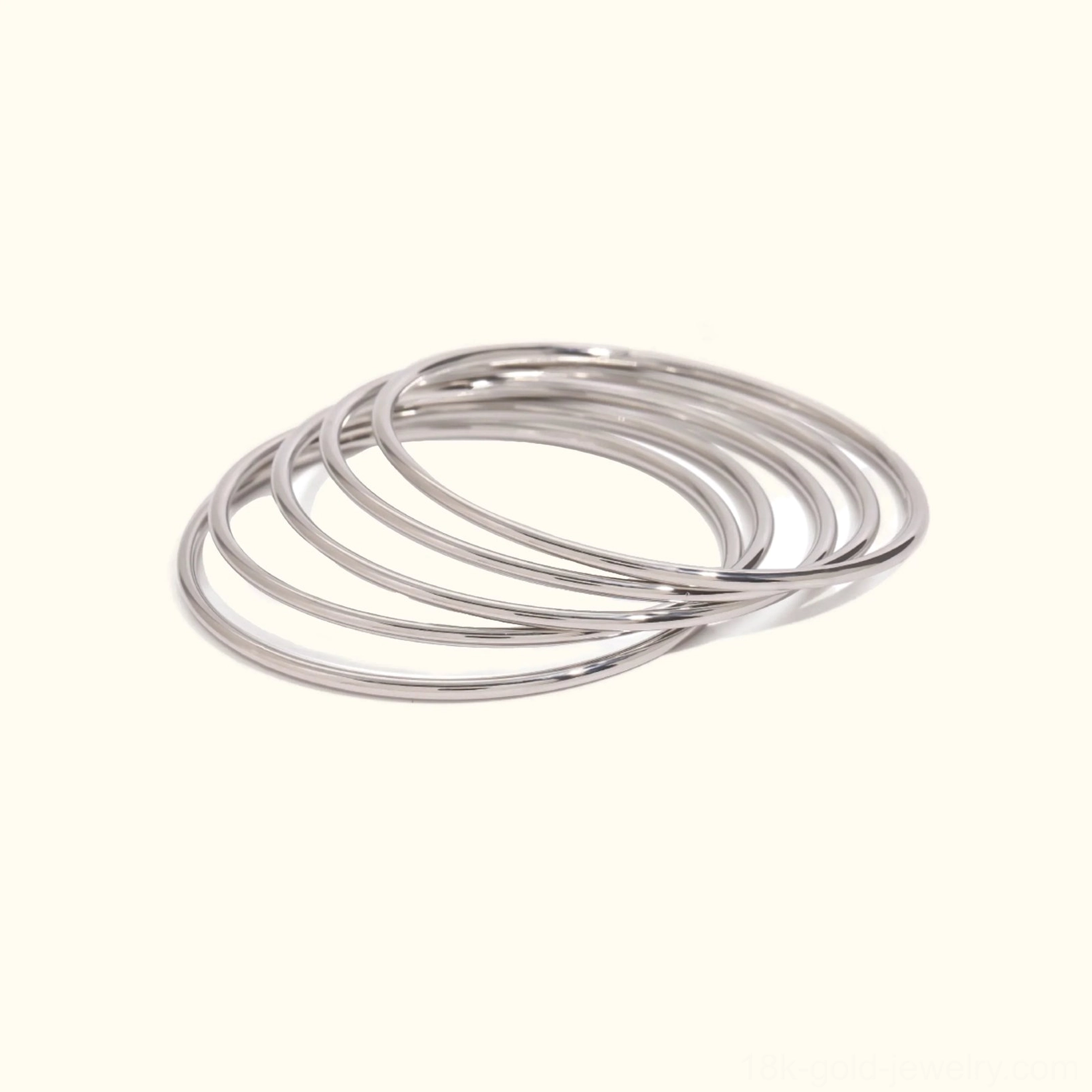 Silver-toned slim bangle bracelets flat lay - polished stackable bangles