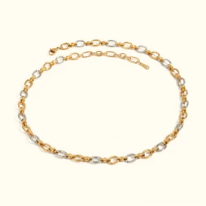 18K two-tone gold necklace with mixed metal oval links, flat lay product photography on plain background