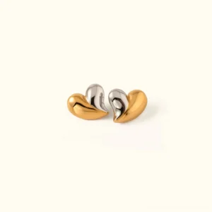 18K two-tone heart stud earrings in mixed gold and silver, flat lay top-down view showcasing puffy heart shape and dual metal finish
