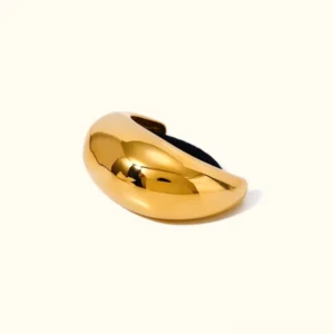 18K yellow gold dome hair cuff flat lay studio shot, plain background, luxury hair accessory