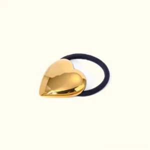 18K yellow gold heart hair cuff with black elastic band, front still life product view on neutral background, mirror-polished finish