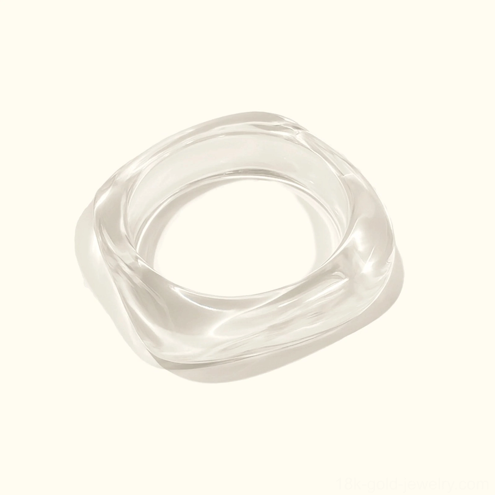 Clear transparent acrylic bangle bracelet with glossy finish, slim rounded square shape in top-down flat lay on white background