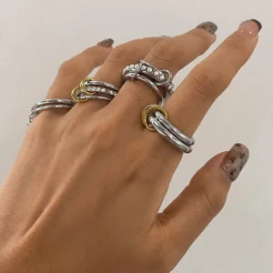 Close-up hand wear of Desiree stacked rings on female model with manicure demonstrating elegant layered styling and diamond simulant sparkle