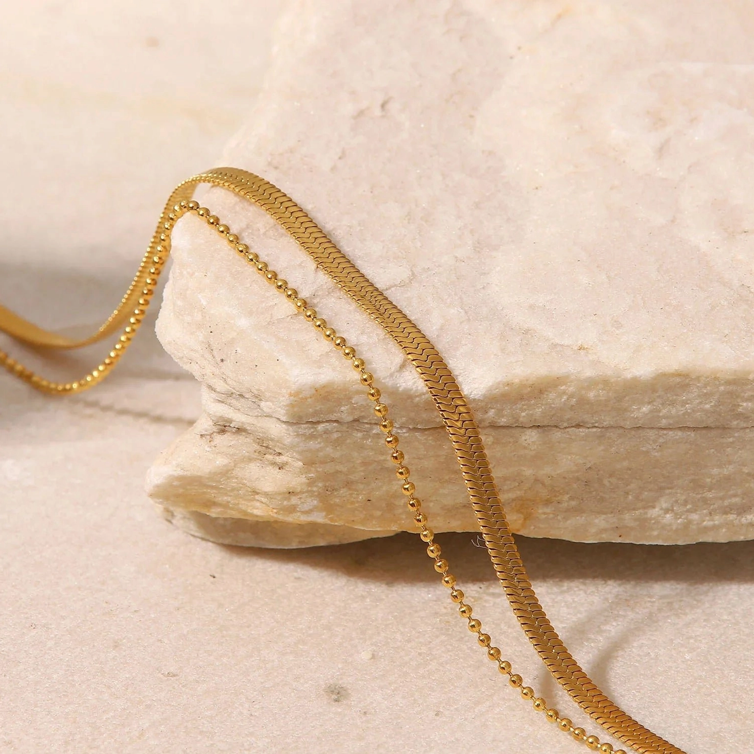 Gold layered anklet draped light stone - polished snake chain and link chain texture