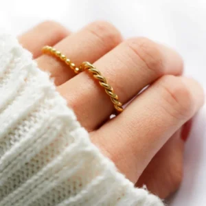 Stacked Gold Twisted Rings on Fingers - Close-Up Side View Demonstrating Multiple Ring Layering and Styling Versatility