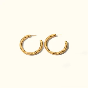 Riley 18K gold twisted hoop earrings flat lay front view polished gold finish geometric design