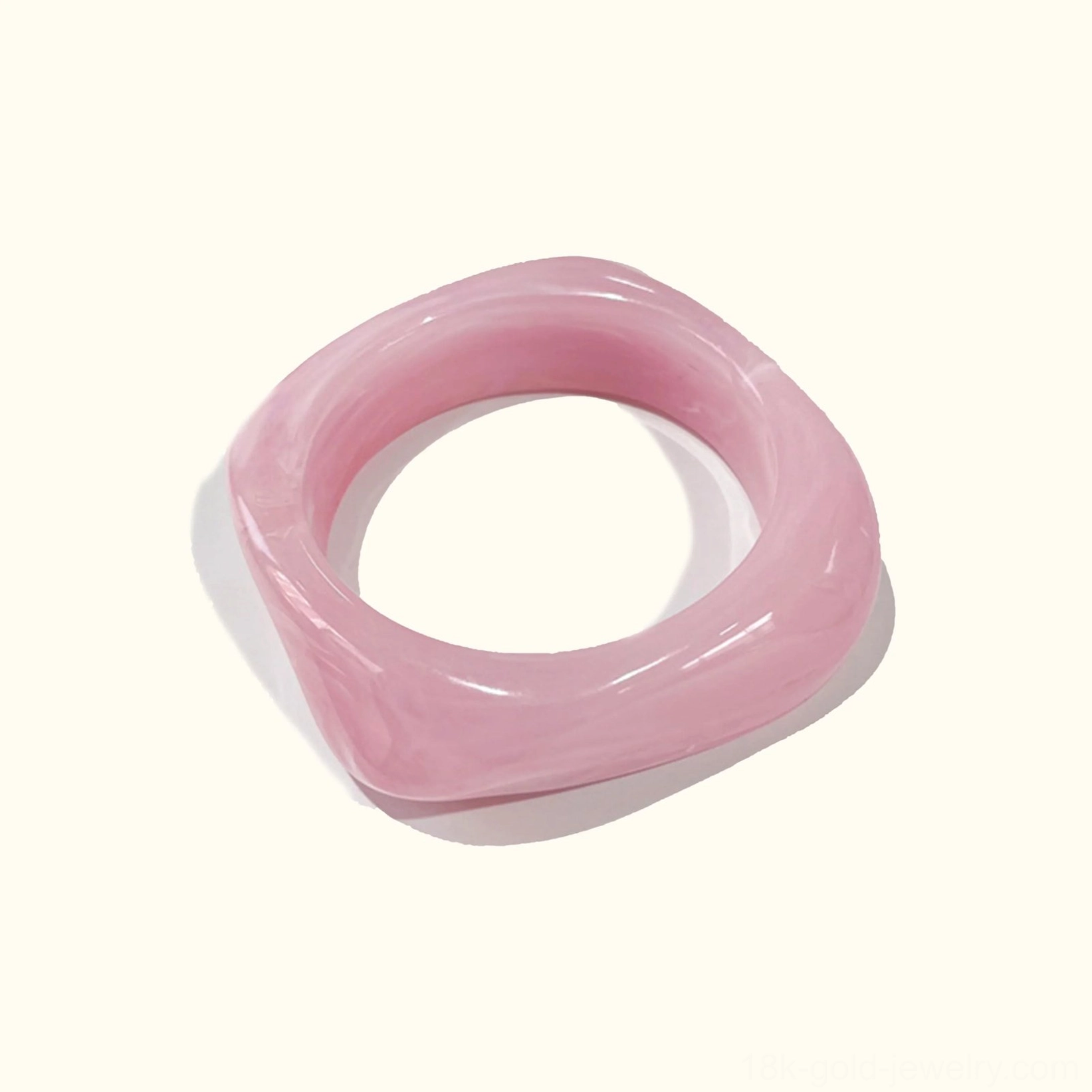 Sakura Blush pale pink solid opaque acrylic bangle bracelet, twisted rounded square design in top-down flat lay composition