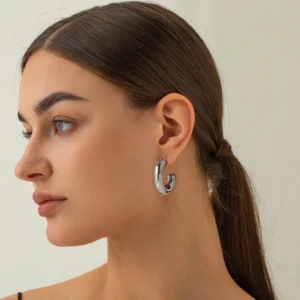 Silver hoop earrings on model - hypoallergenic stainless steel hoops worn on ear profile view