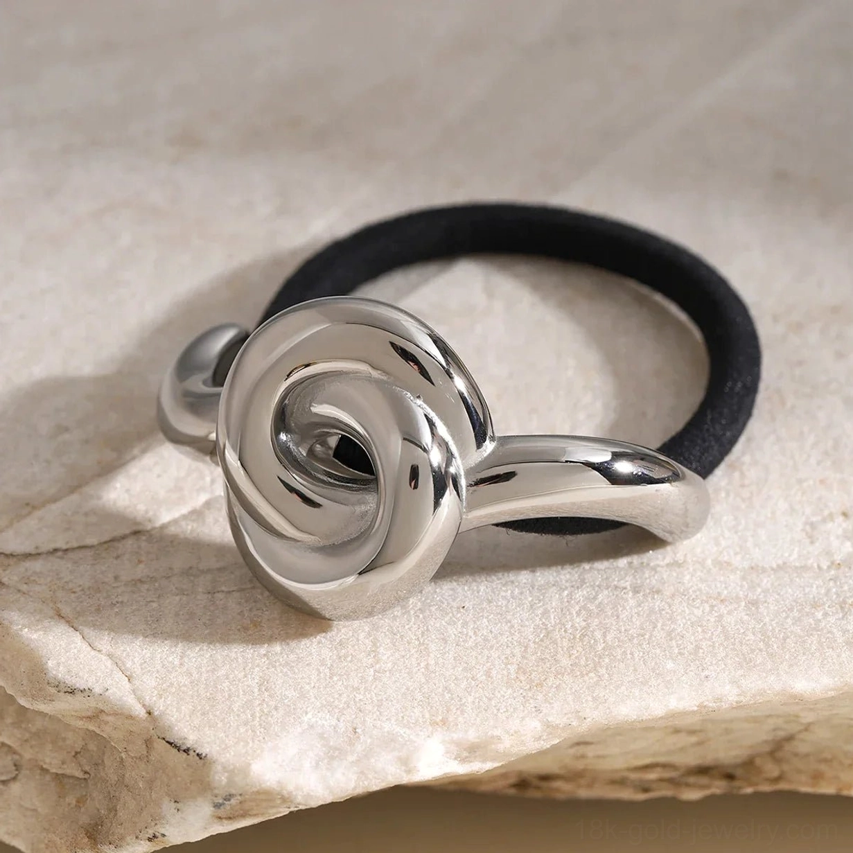 Silver rose knot hair cuff close-up side view twisted knot design detail