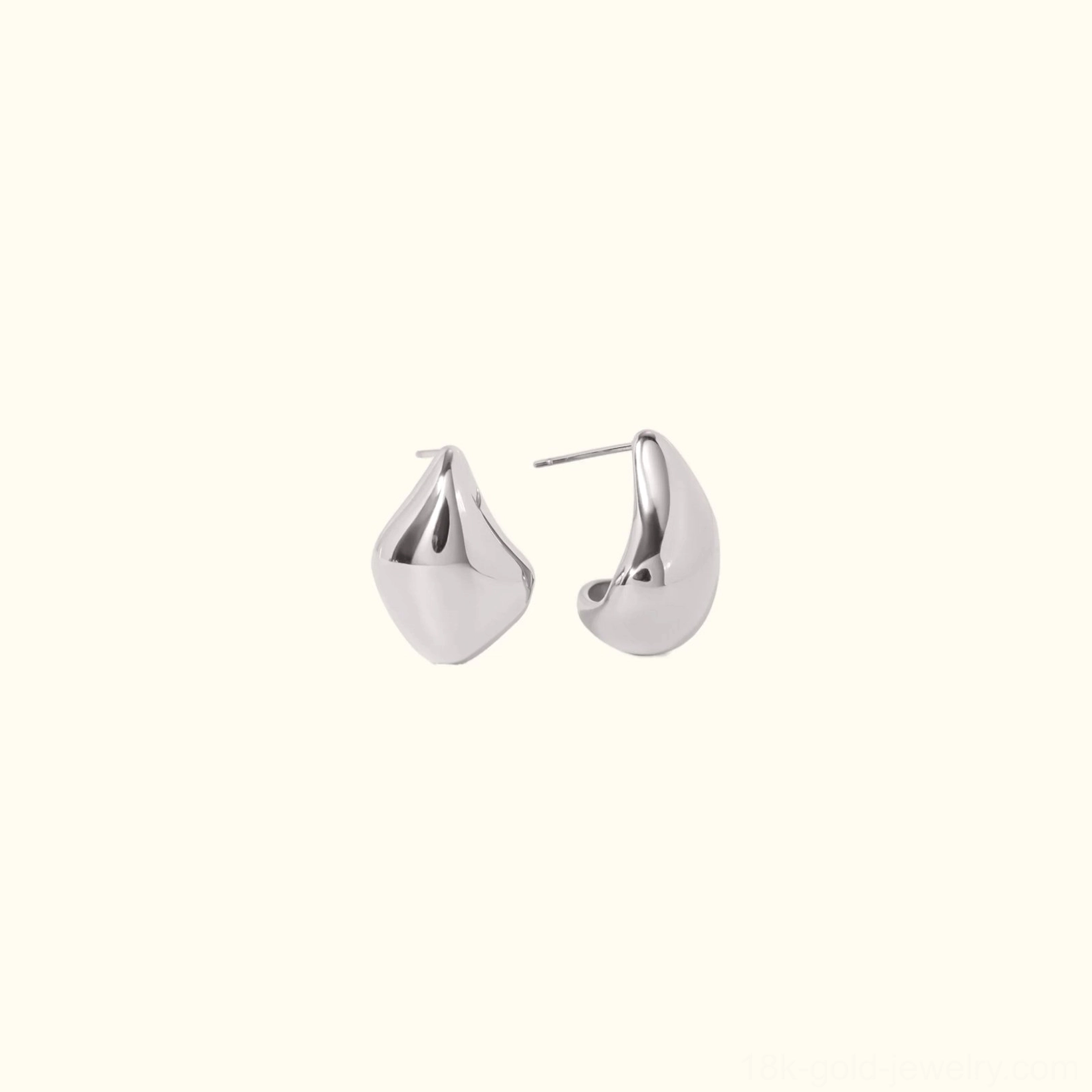 Silver teardrop stud earrings polished flat lay minimalist design alternative