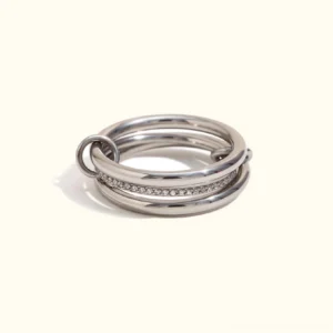 Stacked silver diamond pavé ring set front display view, dual-band design with polished silver and sparkling diamond inlay on off-white background