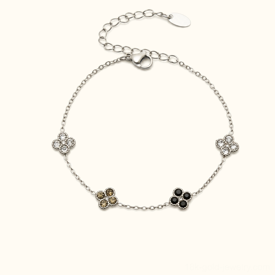 Sterling silver four-leaf clover bracelet with black onyx gemstone charms, sophisticated jewelry photography